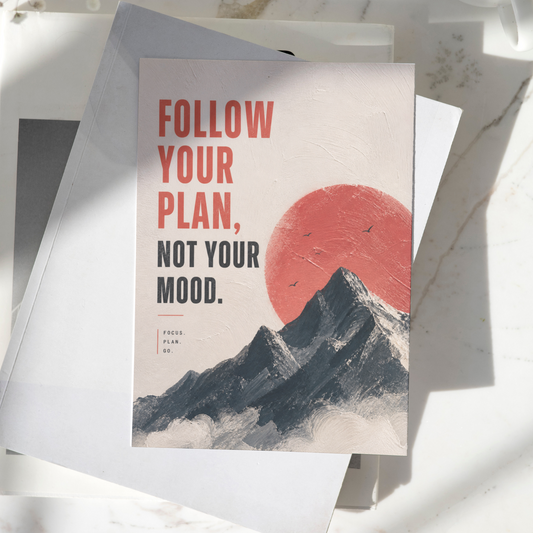 Follow Your Plan Not Your Mood motivational poster displayed on a desk, featuring mountain landscape artwork and a red sun design, premium inspirational wall art print