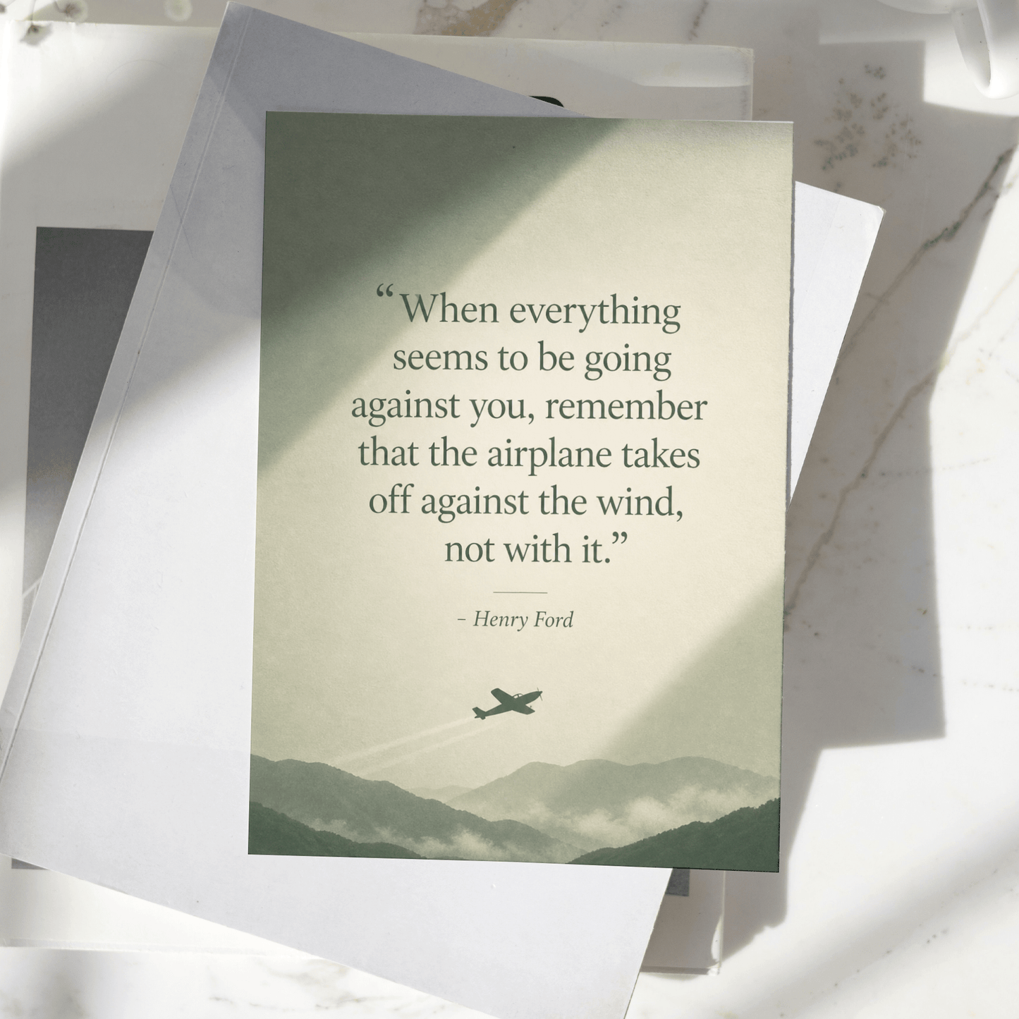 Henry Ford motivational quote poster displayed on a desk, featuring a vintage airplane silhouette and mountain landscape, premium inspirational wall art print.