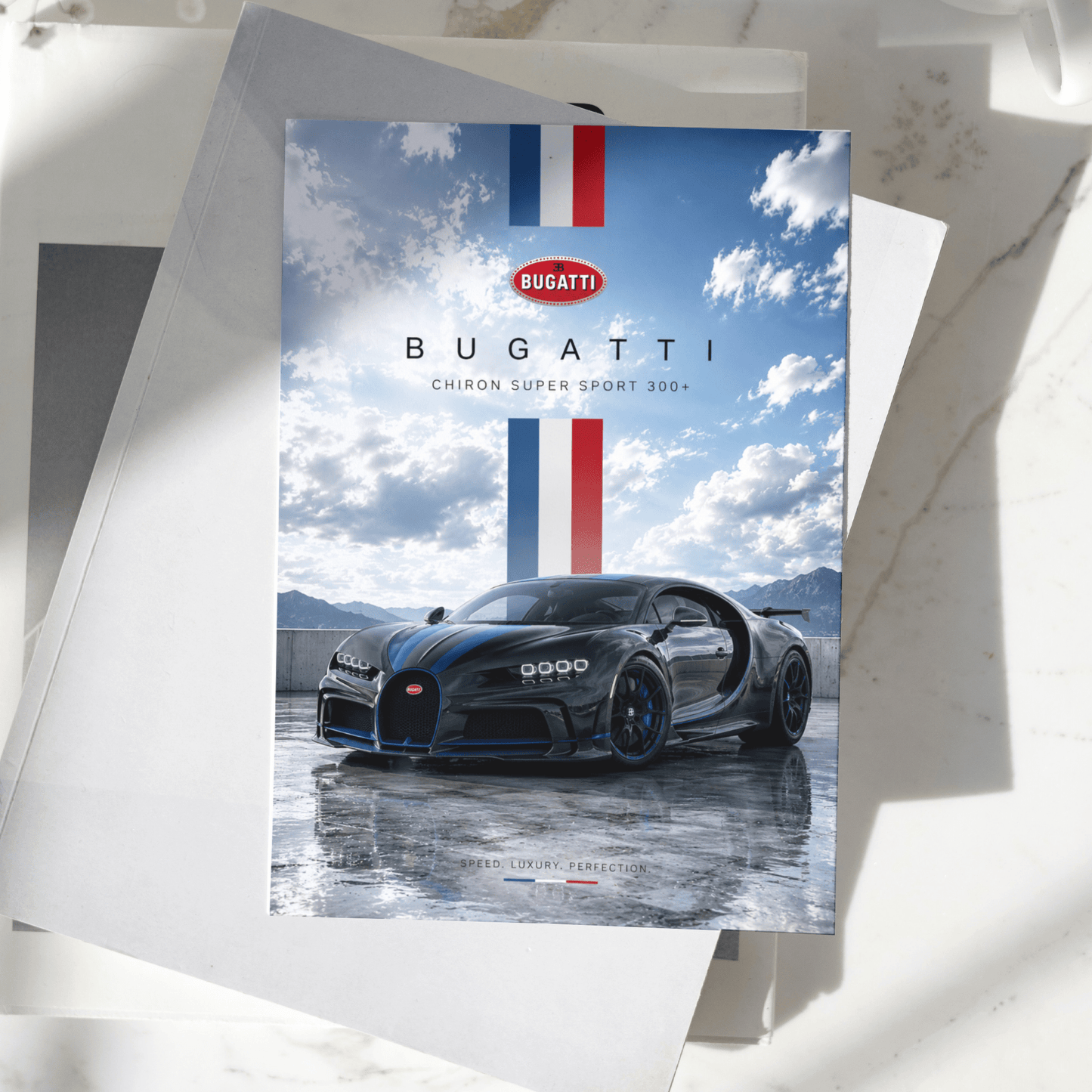 Bugatti Chiron Super Sport 300+ poster displayed on a desk, featuring the iconic black hypercar against a scenic mountain backdrop, premium automotive wall art