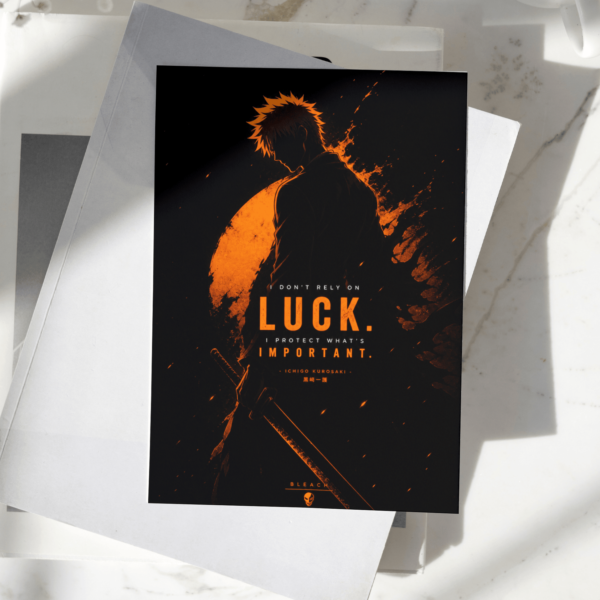 Ichigo Kurosaki Luck Is Important poster displayed on a desk, featuring dark orange silhouette artwork inspired by Bleach, premium anime wall art print