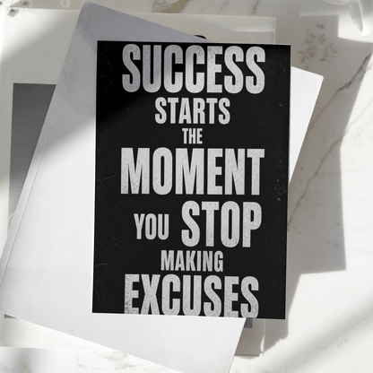 Success Starts The Moment You Stop Making Excuses motivational poster displayed on a desk, featuring bold typography and premium inspirational wall art design