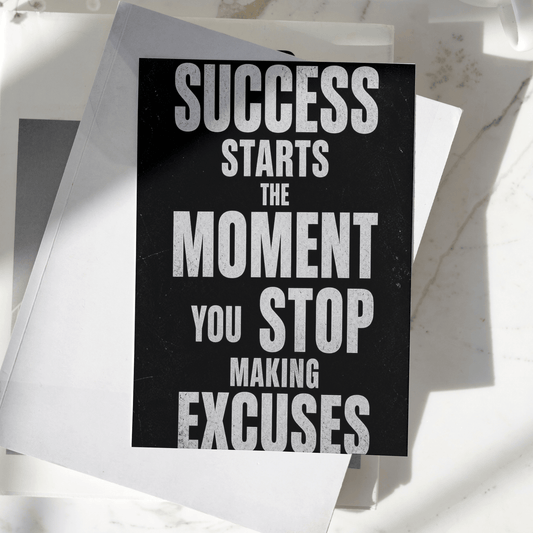 Success Starts The Moment You Stop Making Excuses motivational poster displayed on a desk, featuring bold typography and premium inspirational wall art design