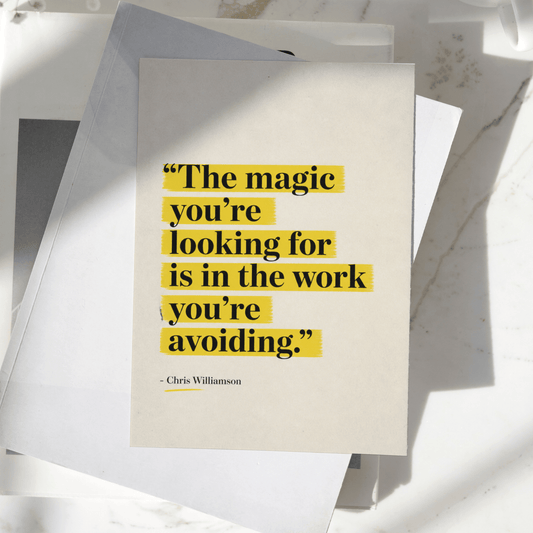 The Magic You're Looking For Is In The Work You're Avoiding motivational poster displayed on a desk, featuring minimalist typography with yellow highlighted text, premium inspirational wall art print.