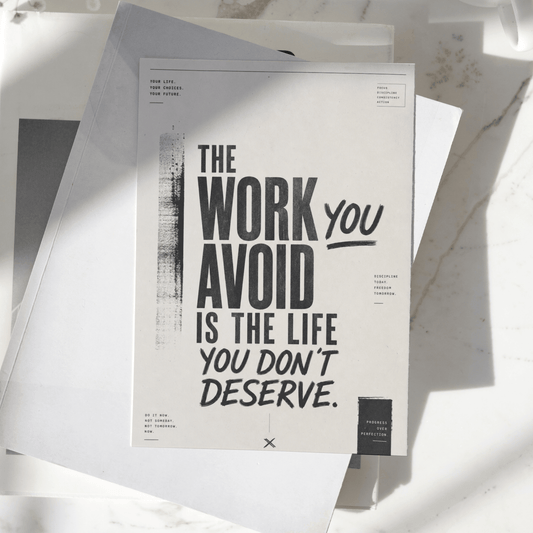 The Work You Avoid Is The Life You Don't Deserve motivational poster displayed on a desk, featuring bold minimalist typography and inspirational wall art design.